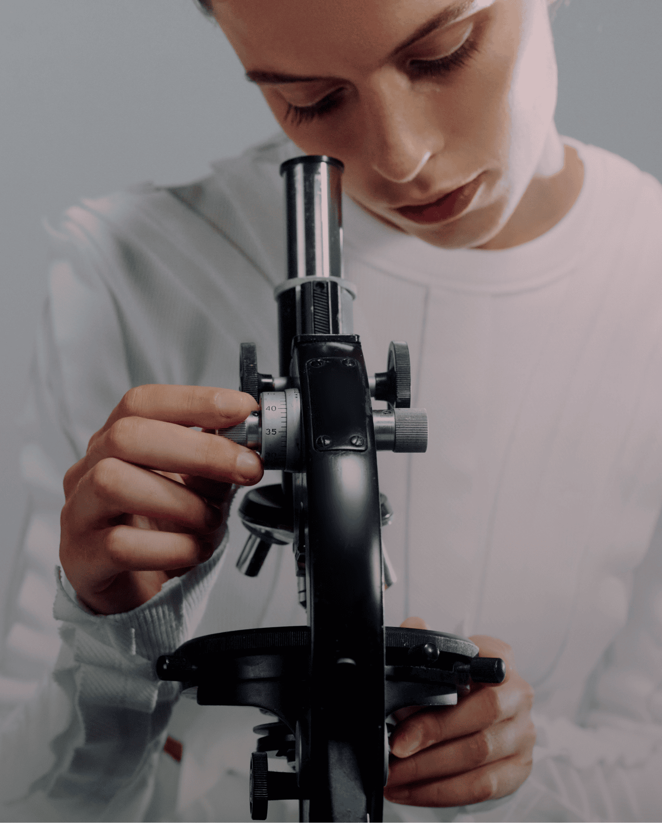 A clinician using a handheld skin-analysis device on a patient